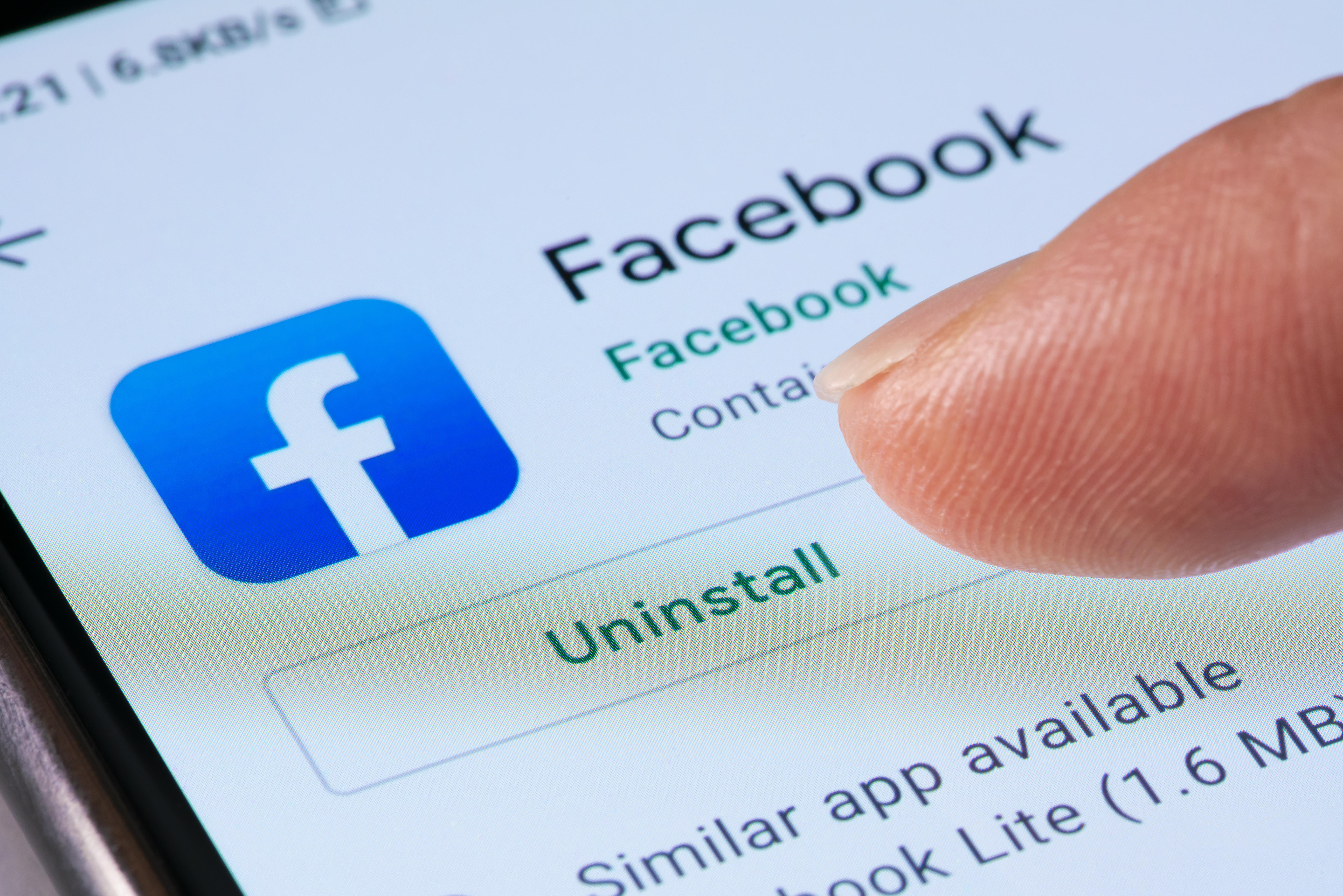 Close-up view of uninstalling Facebook app on a smartphone