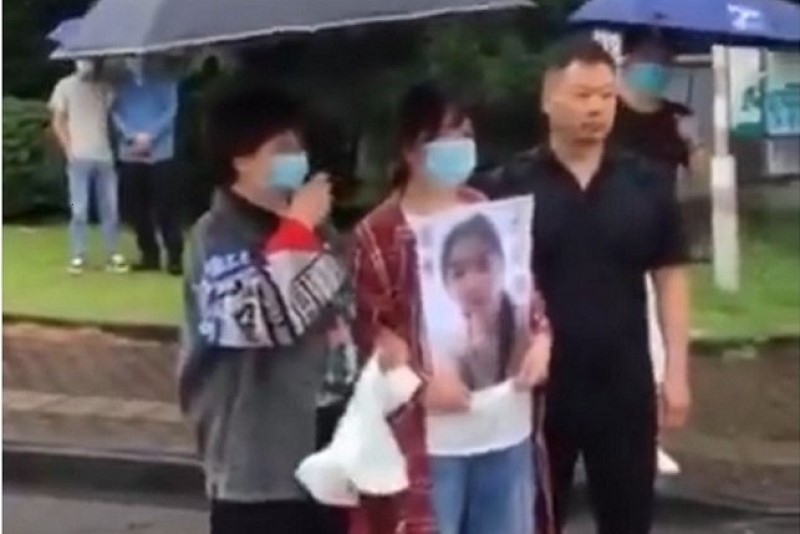 6月19日，宁波工程学院被黑人外教杀害的陈某君家属手举遗像